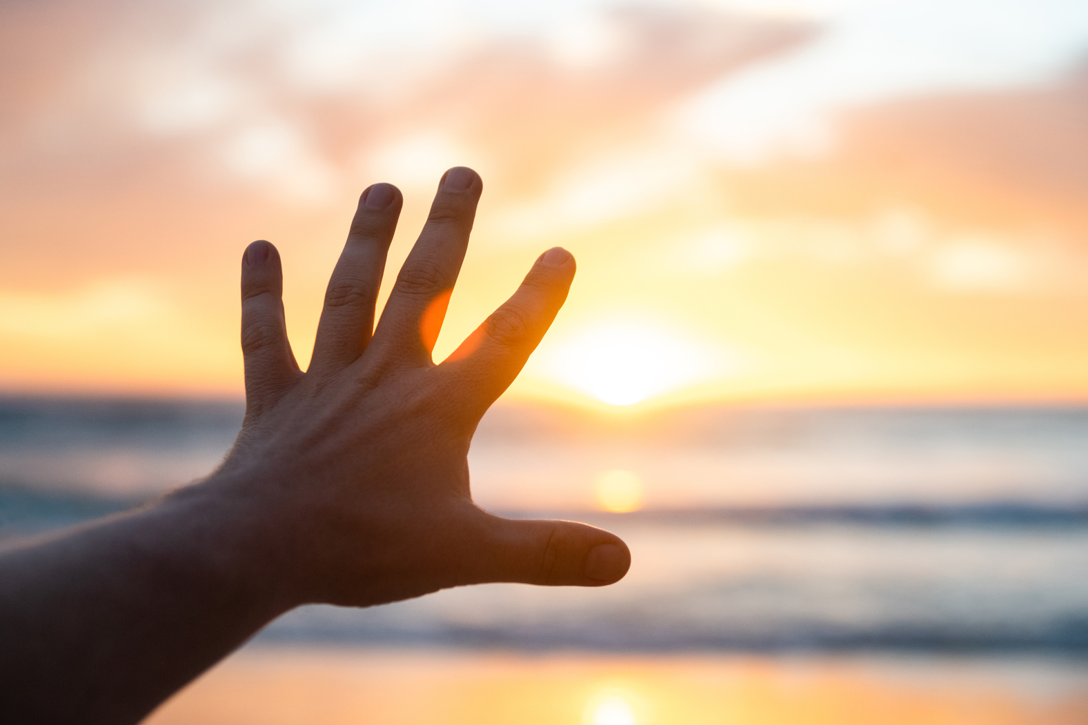 Man's Hand Reaching Towards the Sun